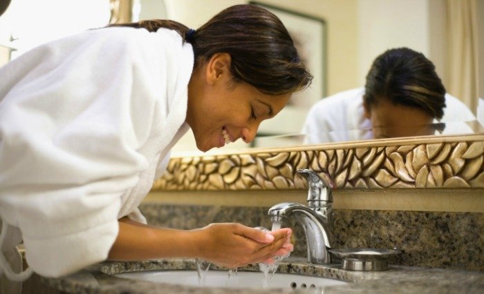 woman washing her face