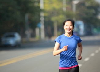 Woman Exercising Running on Road